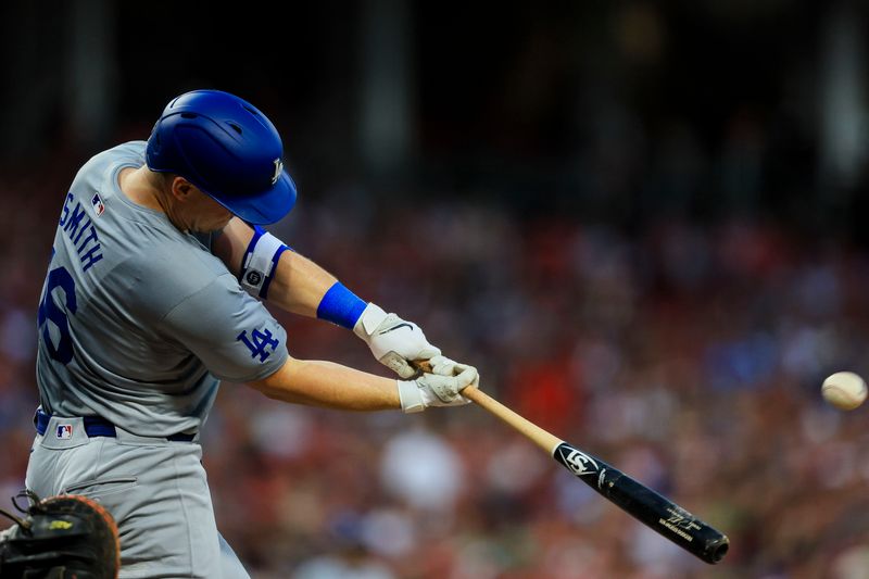 May 24, 2024; Cincinnati, Ohio, USA; Los Angeles Dodgers catcher Will Smith (16) hits a solo home run in the fifth inning against the Cincinnati Reds at Great American Ball Park. Mandatory Credit: Katie Stratman-USA TODAY Sports