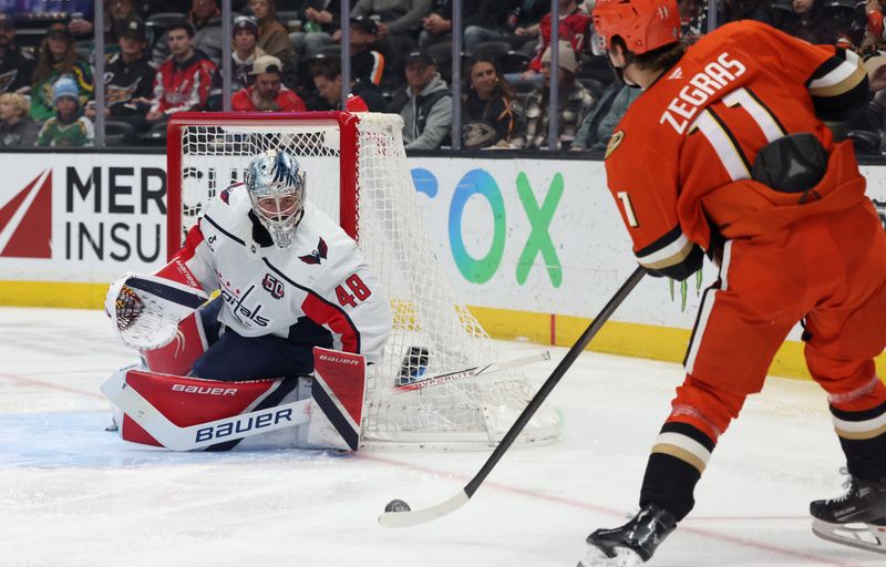 Mar 11, 2025; Anaheim, California, USA; Washington Capitals goaltender Logan Thompson (48) makes a save against Anaheim Ducks center Trevor Zegras (11) during the second period at Honda Center. Mandatory Credit: Jason Parkhurst-Imagn Images