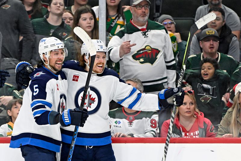 Apr 11, 2023; Saint Paul, Minnesota, USA;  EDITORS NOTE: Obscene gesture     Winnipeg Jets forward Mason Appleton (22) celebrates his goal against the Minnesota Wild with defense Brenden Dillon (5) during the third period at at Xcel Energy Center. Mandatory Credit: Nick Wosika-USA TODAY Sports