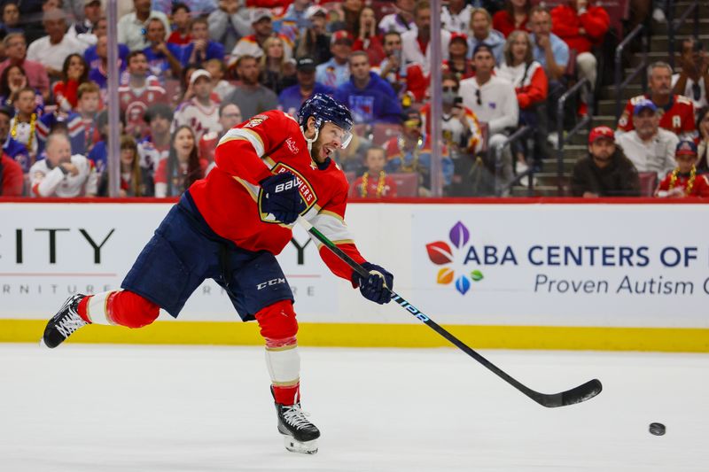 May 26, 2024; Sunrise, Florida, USA; Florida Panthers center Carter Verhaeghe (23) shoots the puck against the New York Rangers during the third period in game three of the Eastern Conference Final of the 2024 Stanley Cup Playoffs at Amerant Bank Arena. Mandatory Credit: Sam Navarro-USA TODAY Sports