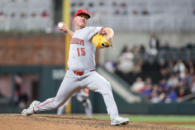 May 6, 2025; Cumberland, Georgia, USA; Cincinnati Reds pitcher Emilio Pagán (15) pitches the ball against the Atlanta Braves during the ninth inning at Truist Park. Mandatory Credit: Jordan Godfree-Imagn Images