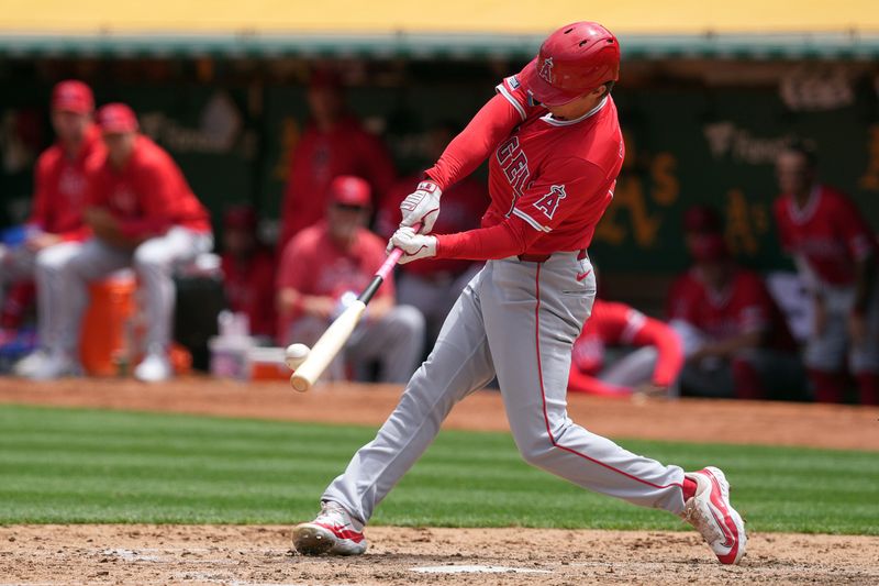 Jul 21, 2024; Oakland, California, USA; Los Angeles Angels center fielder Mickey Moniak (16) hits a home run against the Oakland Athletics during the fifth inning at Oakland-Alameda County Coliseum. Mandatory Credit: Darren Yamashita-USA TODAY Sports