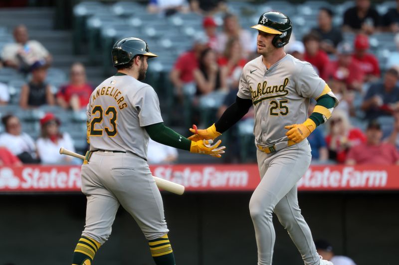 Jul 25, 2024; Anaheim, California, USA;  Oakland Athletics designated hitter Brent Rooker (25) celebrates with catcher Shea Langeliers (23) after hitting a home run during the first inning against the Los Angeles Angels at Angel Stadium. Mandatory Credit: Kiyoshi Mio-USA TODAY Sports