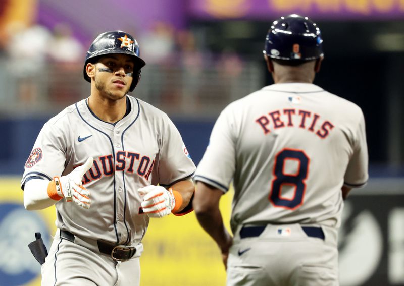 Aug 14, 2024; St. Petersburg, Florida, USA; Houston Astros shortstop Jeremy Pena (3)  high fives third base coach Gary Pettis (8) after he hits a home run against the Tampa Bay Rays during the fifth inning during the fifth inning at Tropicana Field. Mandatory Credit: Kim Klement Neitzel-USA TODAY Sports