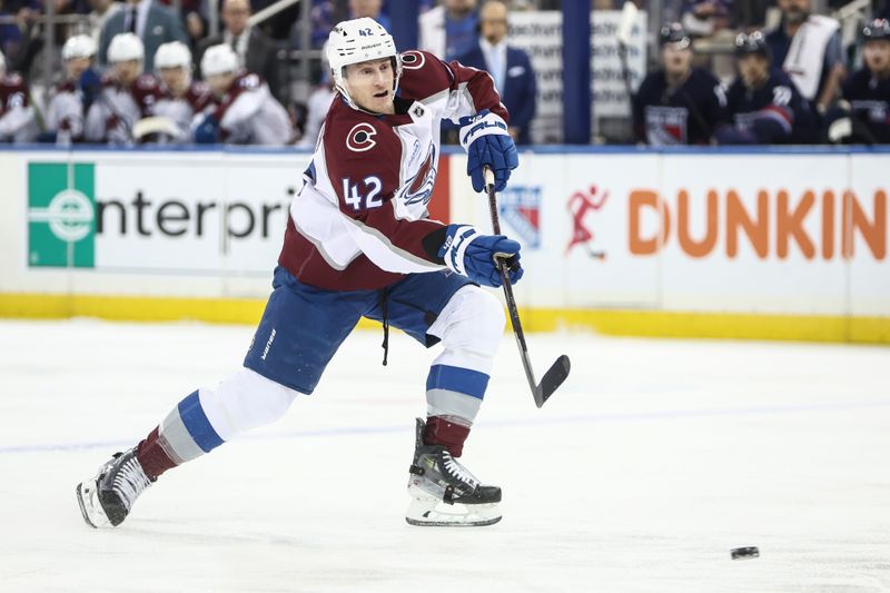 Jan 26, 2025; New York, New York, USA;  Colorado Avalanche defenseman Josh Manson (42) attempts a shot on goal in the first period against the New York Rangers at Madison Square Garden. Mandatory Credit: Wendell Cruz-Imagn Images
