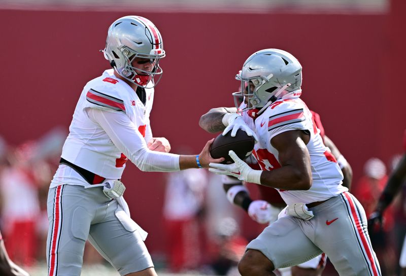 Sep 2, 2023; Bloomington, Indiana, USA; Ohio State Buckeyes quarterback Kyle McCord (6) hands off the ball to Ohio State Buckeyes running back TreVeyon Henderson (32) during the first quarter against the Indiana Hoosiers at Memorial Stadium. Mandatory Credit: Marc Lebryk-USA TODAY Sports