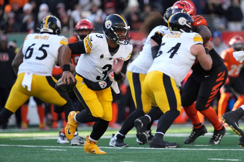 Pittsburgh Steelers quarterback Russell Wilson runs out of the pocket during the first half of an NFL football game against the Cincinnati Bengals, Sunday, Dec. 1, 2024, in Cincinnati. (AP Photo/Kareem Elgazzar)