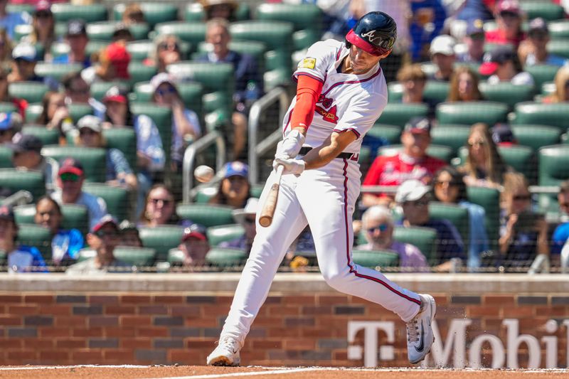 Apr 7, 2024; Cumberland, Georgia, USA; Atlanta Braves first baseman Matt Olson (28) hits a home run against the Arizona Diamondbacks during the second inning at Truist Park. Mandatory Credit: Dale Zanine-USA TODAY Sports