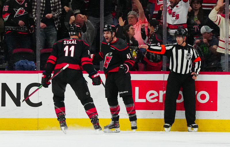 Jan 15, 2024; Raleigh, North Carolina, USA; Carolina Hurricanes left wing Jordan Martinook (48) celebrates his goal with center Jordan Staal (11) against the Los Angeles Kings during the second period at PNC Arena. Mandatory Credit: James Guillory-USA TODAY Sports