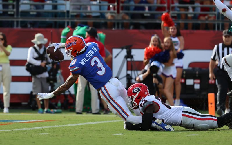 Oct 28, 2023; Jacksonville, Florida, USA; Florida Gators wide receiver Eugene Wilson III (3) runs past Georgia Bulldogs defensive back Tykee Smith (23) for a touchdown during the first quarter at EverBank Stadium. Mandatory Credit: Kim Klement Neitzel-USA TODAY Sports