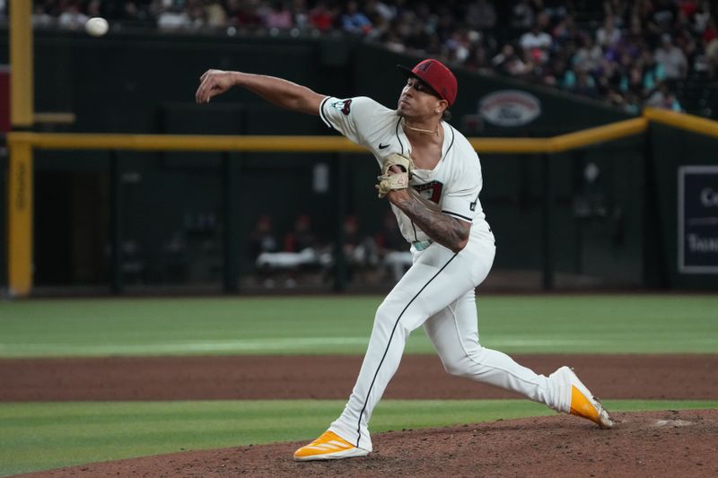 Apr 27, 2025; Phoenix, Arizona, USA; Arizona Diamondbacks pitcher Justin Martinez (63) throws against the Atlanta Braves in the ninth inning at Chase Field. Mandatory Credit: Rick Scuteri-Imagn Images