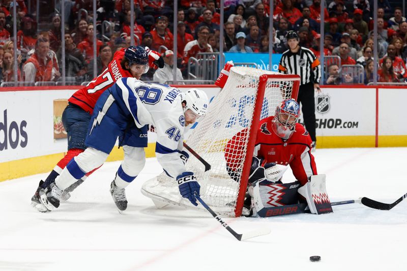 Apr 13, 2024; Washington, District of Columbia, USA; Tampa Bay Lightning defenseman Nick Perbix (48) attempts a wraparound shot on Washington Capitals goaltender Charlie Lindgren (79) as Capitals center Dylan Strome (17) defends in the second period at Capital One Arena. Mandatory Credit: Geoff Burke-USA TODAY Sports