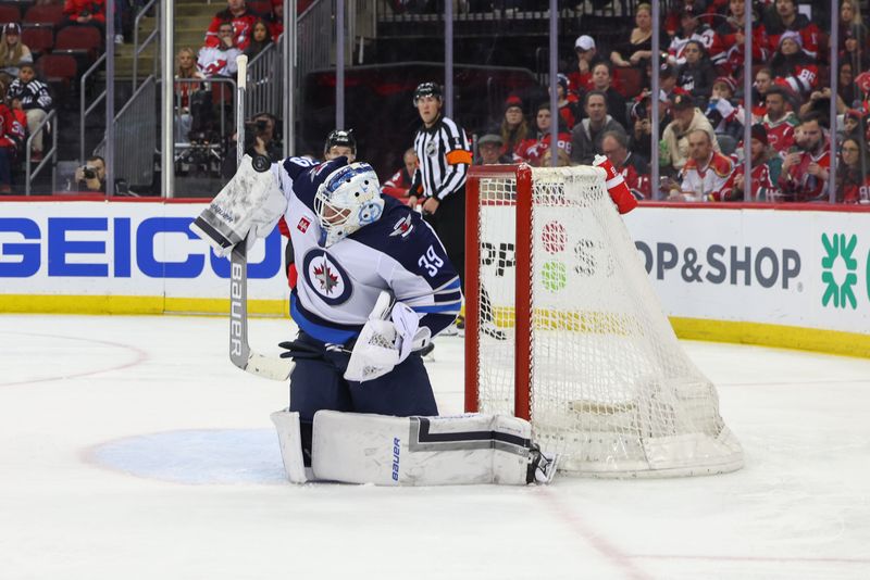 Mar 21, 2024; Newark, New Jersey, USA; Winnipeg Jets goaltender Laurent Brossoit (39) makes a save against the New Jersey Devils during the second period at Prudential Center. Mandatory Credit: Ed Mulholland-USA TODAY Sports