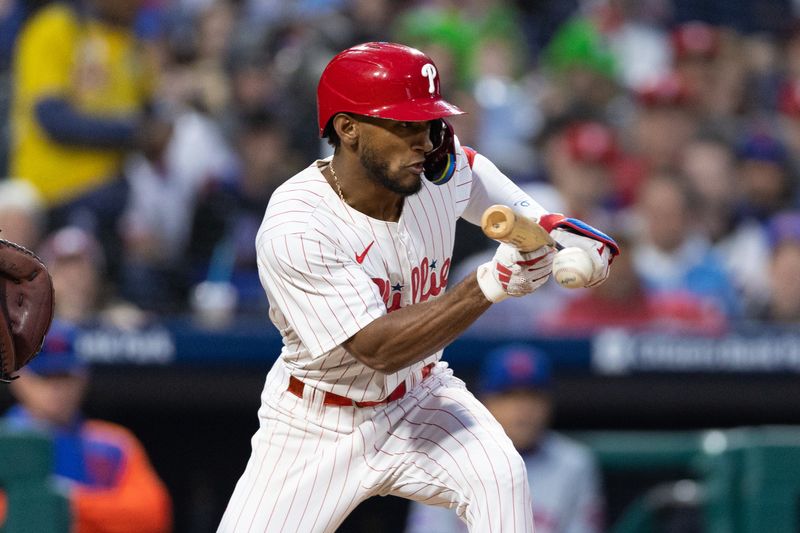 May 15, 2024; Philadelphia, Pennsylvania, USA; Philadelphia Phillies outfielder Johan Rojas (18) bunts against the New York Mets during the fifth inning at Citizens Bank Park. Mandatory Credit: Bill Streicher-USA TODAY Sports