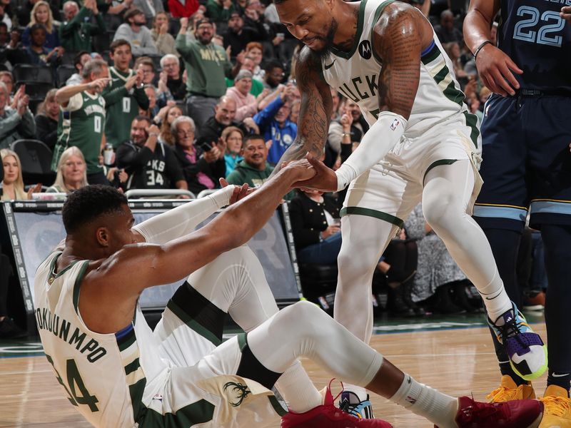 MILWAUKEE, WI - OCTOBER 20: Giannis Antetokounmpo #34 of the Milwaukee Bucks is helped up by Damian Lillard #0 during the preseason game on October 20, 2023 at the Fiserv Forum Center in Milwaukee, Wisconsin. NOTE TO USER: User expressly acknowledges and agrees that, by downloading and or using this Photograph, user is consenting to the terms and conditions of the Getty Images License Agreement. Mandatory Copyright Notice: Copyright 2023 NBAE (Photo by Gary Dineen/NBAE via Getty Images).