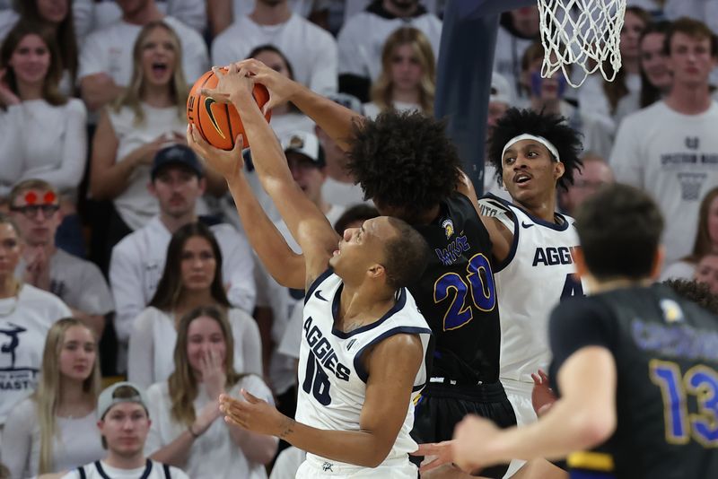 Jan 30, 2024; Logan, Utah, USA; San Jose State Spartans forward Christian Wise (20) battles Utah State Aggies guard Darius Brown II (10) and guard Ian Martinez (4) for a rebound during the second half at Dee Glen Smith Spectrum. Mandatory Credit: Rob Gray-USA TODAY Sports