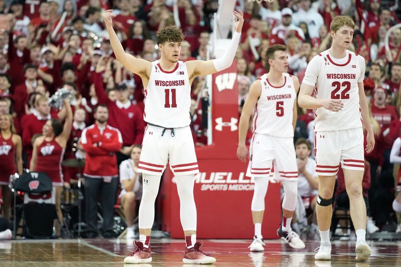 Feb 18, 2023; Madison, Wisconsin, USA; Wisconsin Badgers guard Max Klesmit (11) engages with the crowd after making a three-point shot during the second half against the Rutgers Scarlet Knights at the Kohl Center. Mandatory Credit: Kayla Wolf-USA TODAY Sports