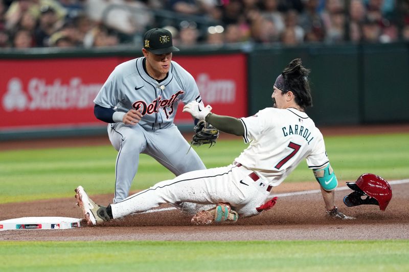 May 19, 2024; Phoenix, Arizona, USA; Arizona Diamondbacks outfielder Corbin Carroll (7) beats a throw to Detroit Tigers third base Gio Urshela (13) to reach safely for a triple during the first inning at Chase Field. Mandatory Credit: Joe Camporeale-USA TODAY Sports