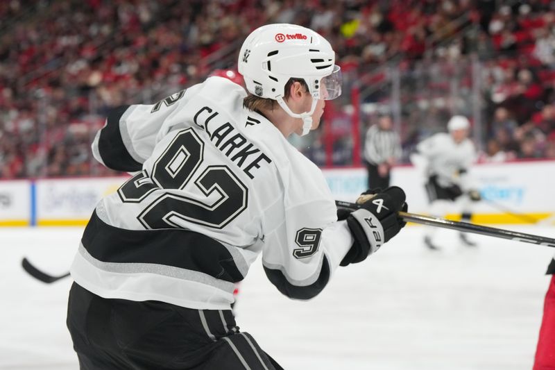 Feb 1, 2026; Raleigh, North Carolina, USA; Los Angeles Kings defenseman Brandt Clarke (92) takes a shot against the Carolina Hurricanes during the second period at Lenovo Center. Mandatory Credit: James Guillory-Imagn Images