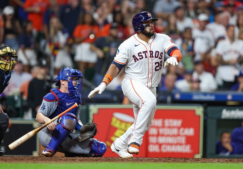 Jul 27, 2024; Houston, Texas, USA; Houston Astros first baseman Jon Singleton (28) hits an RBI single during the eighth inning against the Los Angeles Dodgers at Minute Maid Park. Mandatory Credit: Troy Taormina-USA TODAY Sports