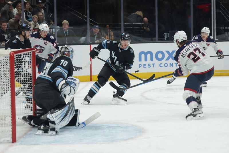 Jan 31, 2025; Salt Lake City, Utah, USA;  Columbus Blue Jackets center Zachary Aston-Reese (27) tries to control the puck against the Utah Hockey Club during the third period at Delta Center. Mandatory Credit: Chris Nicoll-Imagn Images