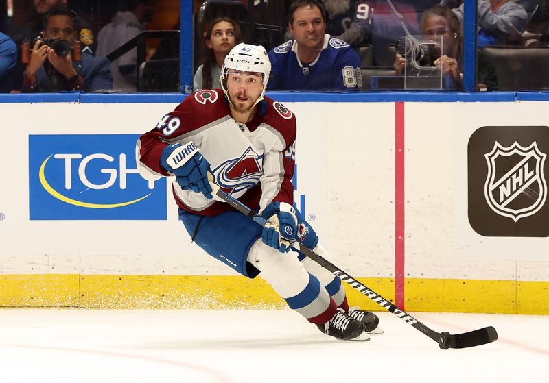 Feb 15, 2024; Tampa, Florida, USA; Colorado Avalanche defenseman Samuel Girard (49) skates with the puck against the Tampa Bay Lightning during the second period at Amalie Arena. Mandatory Credit: Kim Klement Neitzel-USA TODAY Sports