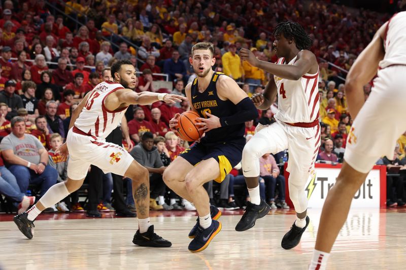 Feb 27, 2023; Ames, Iowa, USA; West Virginia Mountaineers guard Erik Stevenson (10) drives on Iowa State Cyclones guard Demarion Watson (4) during the first half at James H. Hilton Coliseum. Mandatory Credit: Reese Strickland-USA TODAY Sports