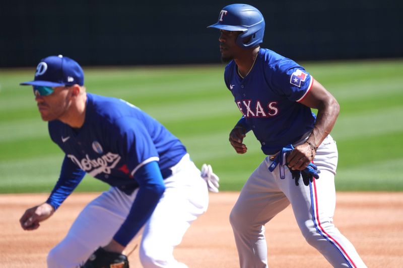 Mar 9, 2024; Phoenix, Arizona, USA; Texas Rangers left fielder Elder Hernandez (38) leads off first base as Los Angeles Dodgers first baseman Freddie Freeman (5) covers the bag during the third inning at Camelback Ranch-Glendale. Mandatory Credit: Joe Camporeale-USA TODAY Sports