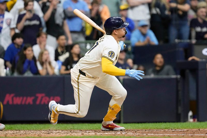 May 28, 2024; Milwaukee, Wisconsin, USA;  Milwaukee Brewers shortstop Willy Adames (27) drives in a run during the ninth inning against the Chicago Cubs at American Family Field. Mandatory Credit: Jeff Hanisch-USA TODAY Sports