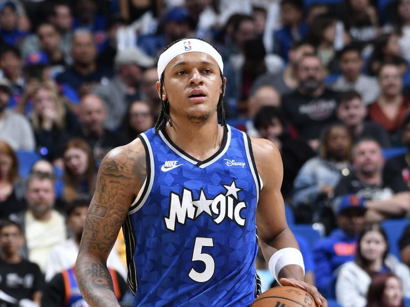 ORLANDO, FL - FEBRUARY 14: Paolo Banchero #5 of the Orlando Magic dribbles the ball during the game against the New York Knicks on February 14, 2024 at the Kia Center in Orlando, Florida. NOTE TO USER: User expressly acknowledges and agrees that, by downloading and or using this photograph, User is consenting to the terms and conditions of the Getty Images License Agreement. Mandatory Copyright Notice: Copyright 2024 NBAE (Photo by Fernando Medina/NBAE via Getty Images)