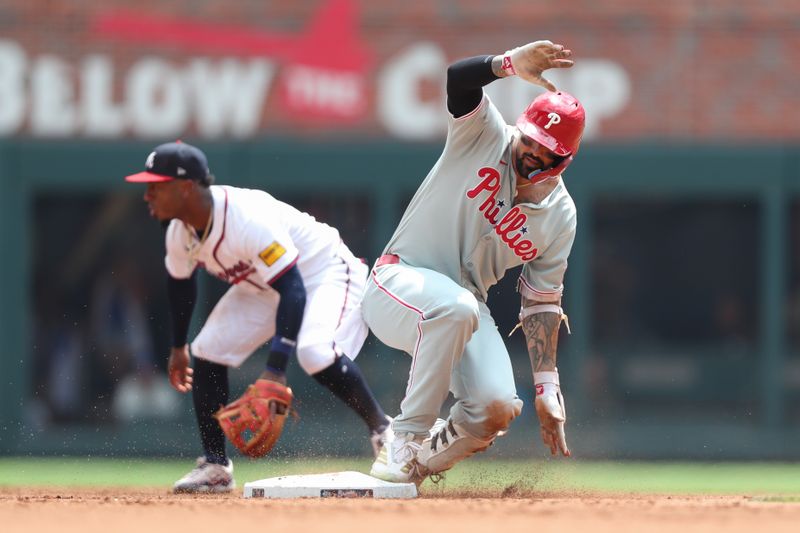 Jun 29, 2025; Cumberland, Georgia, Philadelphia Phillies right fielder Nick Castellanos (8) is safe on second base in front of Atlanta Braves second baseman Ozzie Albies (1) during the sixth inning at Truist Park. Mandatory Credit: Mady Mertens-Imagn Images