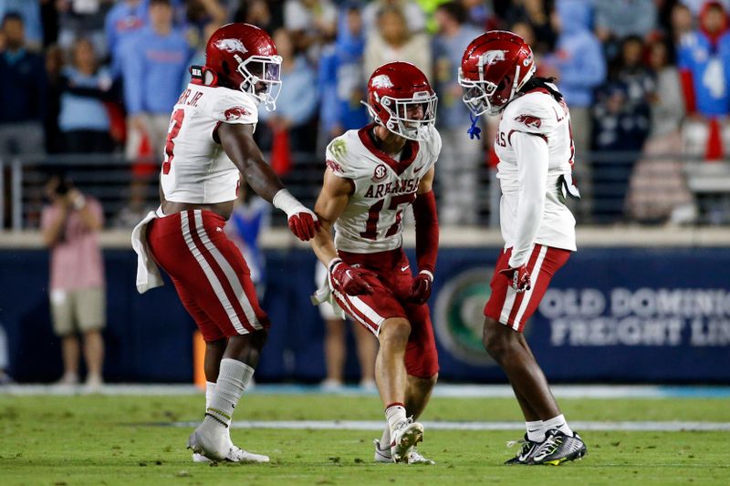 Oct 7, 2023; Oxford, Mississippi, USA; Arkansas Razorbacks linebacker Antonio Grier (3) and defensive back Lorando Johnson (1) react with defensive back Hudson Clark (17) after a defensive stop during the first half against the Mississippi Rebels at Vaught-Hemingway Stadium. Mandatory Credit: Petre Thomas-USA TODAY Sports