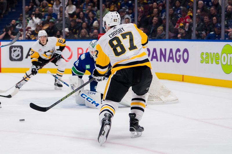 sFeb 27, 2024; Vancouver, British Columbia, CAN; Pittsburgh Penguins forward Sidney Crosby (87) passes the puck to forward Rickard Rakell (67) as Vancouver Canucks goalie Thatcher Demko (35) looks on in the second period at Rogers Arena. Mandatory Credit: Bob Frid-USA TODAY Sports