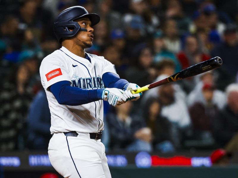 Apr 29, 2025; Seattle, Washington, USA; Seattle Mariners designated hitter Jorge Polanco (7) hits a two-run home run against the Los Angeles Angels during the seventh inning at T-Mobile Park. Mandatory Credit: Joe Nicholson-Imagn Images