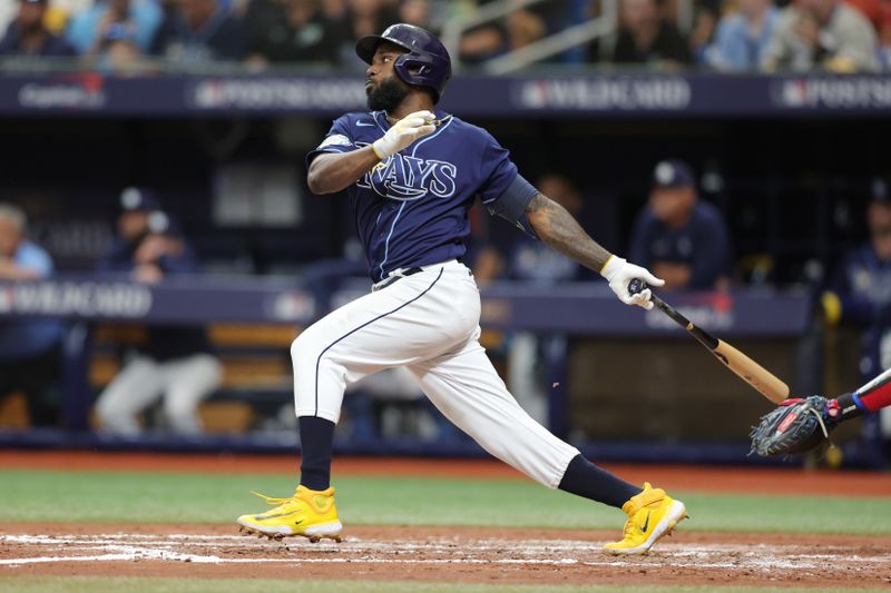 Oct 4, 2023; St. Petersburg, Florida, USA; Tampa Bay Rays left fielder Randy Arozarena (56) hits a single against the Texas Rangers in the fourth inning during game two of the Wildcard series for the 2023 MLB playoffs at Tropicana Field. Mandatory Credit: Nathan Ray Seebeck-USA TODAY Sports