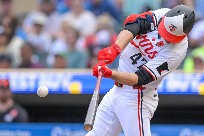 May 27, 2024; Minneapolis, Minnesota, USA; Minnesota Twins infielder Edouard Julien (47) hits a single against the Kansas City Royals during the seventh inning at Target Field. Mandatory Credit: Nick Wosika-USA TODAY Sports