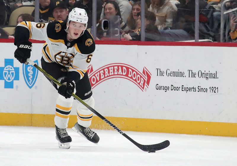 Mar 1, 2025; Pittsburgh, Pennsylvania, USA;  Boston Bruins defenseman Mason Lohrei (6) skates with the puck against the Pittsburgh Penguins during the second period at PPG Paints Arena. Mandatory Credit: Charles LeClaire-Imagn Images