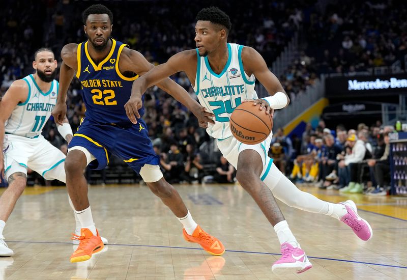 SAN FRANCISCO, CALIFORNIA - FEBRUARY 23: Brandon Miller #24 of the Charlotte Hornets dribbling the ball looks to drive towards the basket on Andrew Wiggins #22 of the Golden State Warriors during the third quarter of an NBA basketball game at Chase Center on February 23, 2024 in San Francisco, California. NOTE TO USER: User expressly acknowledges and agrees that, by downloading and or using this photograph, User is consenting to the terms and conditions of the Getty Images License Agreement. (Photo by Thearon W. Henderson/Getty Images)