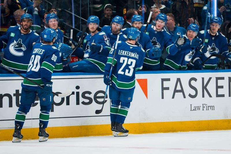 Oct 3, 2025; Vancouver, British Columbia, CAN; Vancouver Canucks forward Braeden Cootes (80) and forward Jonathan Lekkerimaki (23) celebrate Lekkerimaki’s goal against the Edmonton Oilers in the first period at Rogers Arena. Mandatory Credit: Bob Frid-Imagn Images