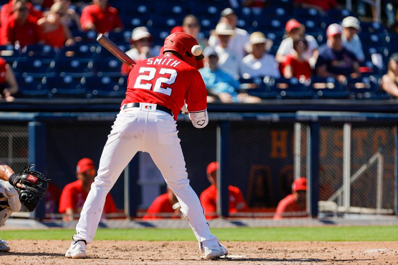 Feb 28, 2023; West Palm Beach, Florida, USA; Washington Nationals first baseman Dominic Smith (22) gets hit by a pitch during the fourth inning against the St. Louis Cardinals at The Ballpark of the Palm Beaches. Mandatory Credit: Sam Navarro-USA TODAY Sports