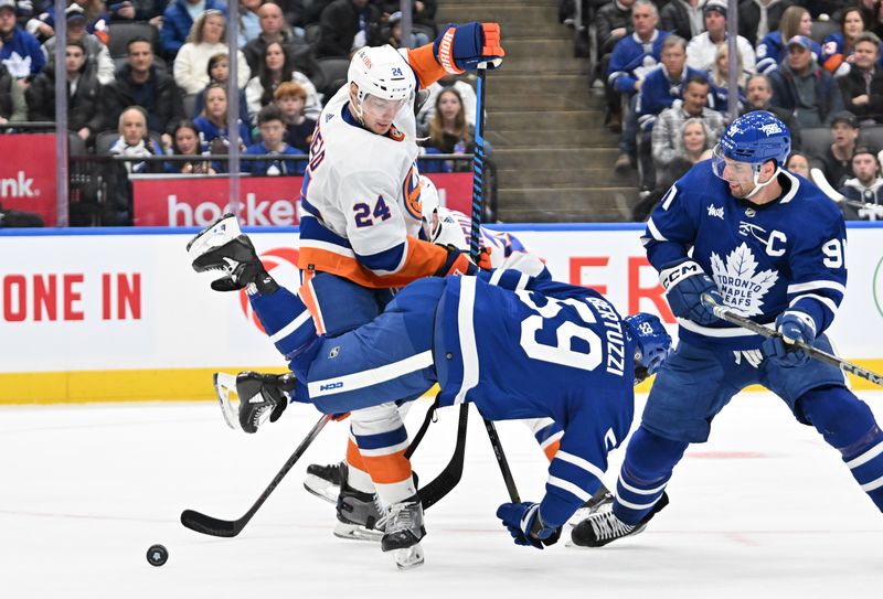 Feb 5, 2024; Toronto, Ontario, CAN;   New York Islanders defenseman Scott Mayfield (24) knocks over Toronto Maple Leafs forward Tyler Bertuzzi (59) in the third period at Scotiabank Arena. Mandatory Credit: Dan Hamilton-USA TODAY Sports