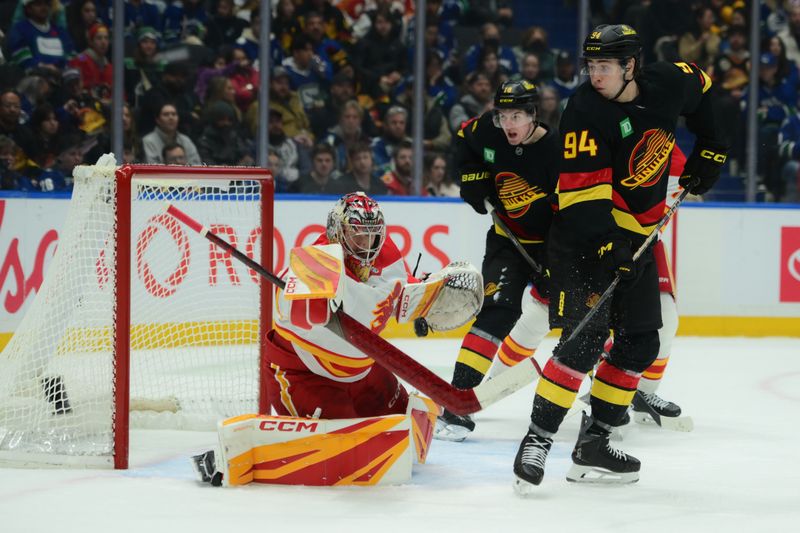 Nov 23, 2025; Vancouver, British Columbia, CAN;  Calgary Flames goaltender Dustin Wolf (32) defends against Vancouver Canucks center Linus Karlsson (94) during the third period at Rogers Arena. Mandatory Credit: Simon Fearn-Imagn Images