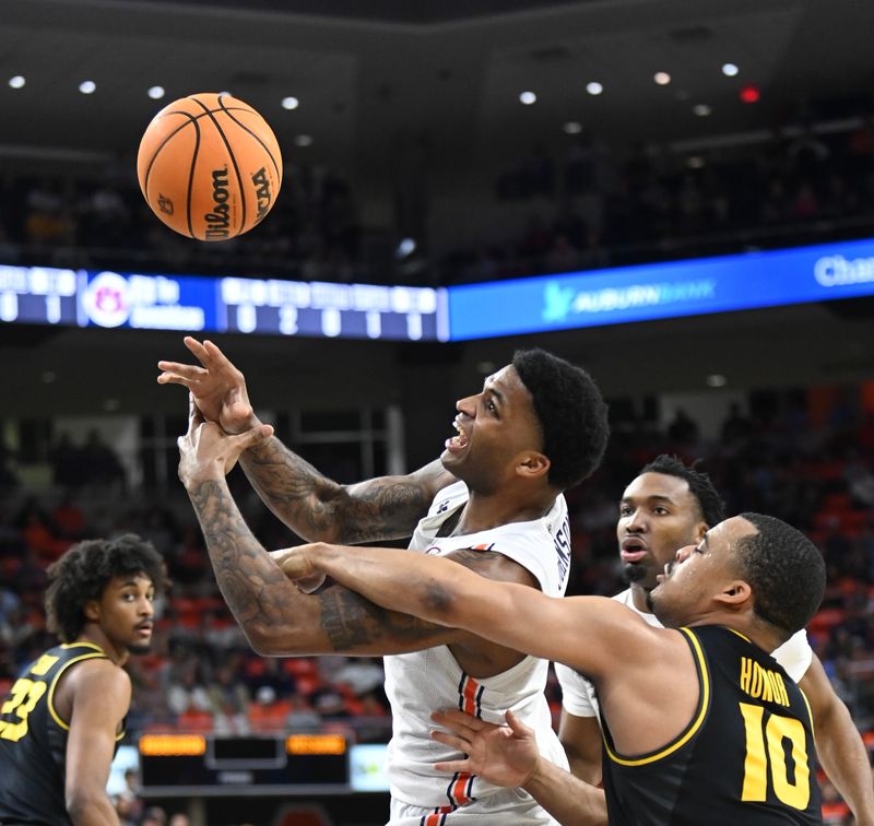 Feb 14, 2023; Auburn, Alabama, USA;  Missouri Tigers guard Nick Honor (10) blocks a shot by Auburn Tigers guard K.D. Johnson (0) during the second half at Neville Arena. Mandatory Credit: Julie Bennett-USA TODAY Sports