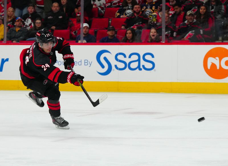 Dec 2, 2023; Raleigh, North Carolina, USA; Carolina Hurricanes center Seth Jarvis (24) takes shot against the Buffalo Sabres during the third period at PNC Arena. Mandatory Credit: James Guillory-USA TODAY Sports