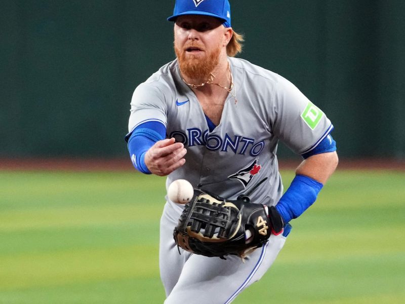 Jul 12, 2024; Phoenix, Arizona, USA; Toronto Blue Jays first base Justin Turner (2) flips the ball against the Arizona Diamondbacks during the first inning at Chase Field. Mandatory Credit: Joe Camporeale-USA TODAY Sports