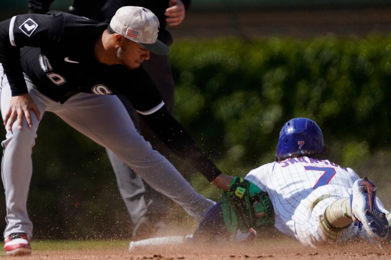 May 18, 2025; Chicago, Illinois, USA; Chicago Cubs shortstop Dansby Swanson (7) steals second base as Chicago White Sox second base Lenyn Sosa (50) makes a tag during the eighth inning at Wrigley Field. Mandatory Credit: David Banks-Imagn Images