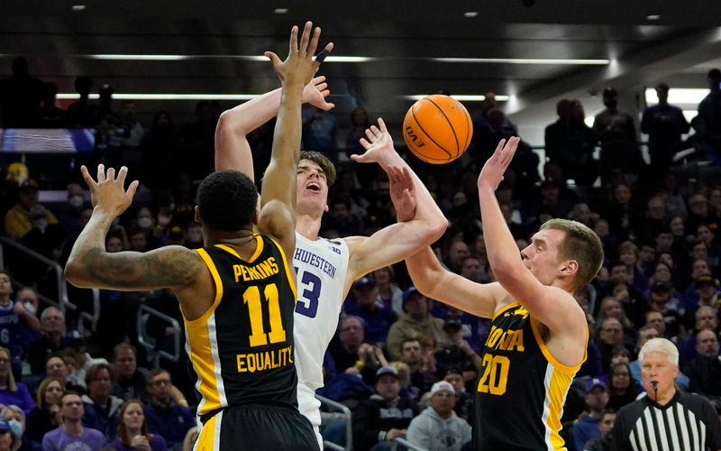 Feb 19, 2023; Evanston, Illinois, USA; Iowa Hawkeyes forward Payton Sandfort (20) fouls Northwestern Wildcats guard Brooks Barnhizer (13) during the second half at Welsh-Ryan Arena. Mandatory Credit: David Banks-USA TODAY Sports