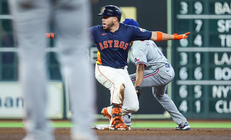 Apr 14, 2024; Houston, Texas, USA; Houston Astros catcher Victor Caratini (17) is safe at second base with an RBI double during the fourth inning against the Texas Rangers at Minute Maid Park. Mandatory Credit: Troy Taormina-USA TODAY Sports