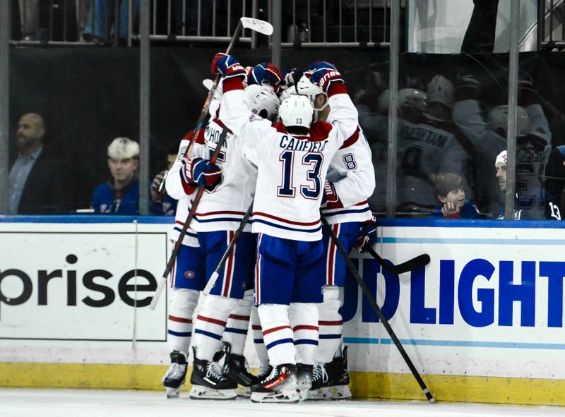 Nov 30, 2024; New York, New York, USA; Montreal Canadiens center Nick Suzuki (14) celebrates with teammates after scoring a goal against the New York Rangers during the third period at Madison Square Garden. Mandatory Credit: John Jones-Imagn Images