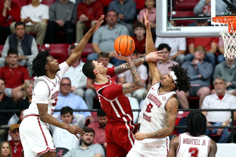 Feb 18, 2026; Tuscaloosa, Alabama, USA; Alabama Crimson Tide forwards London Jemison (6) and Amari Allen (5) block Arkansas Razorback forward Trevon Brazile (7) during the second half at Coleman Coliseum. Mandatory Credit: David Leong-Imagn Images